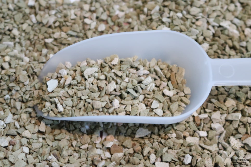 Soil being amended with zeolite conditioner in a field, close-up of soil texture and moisture-rich a