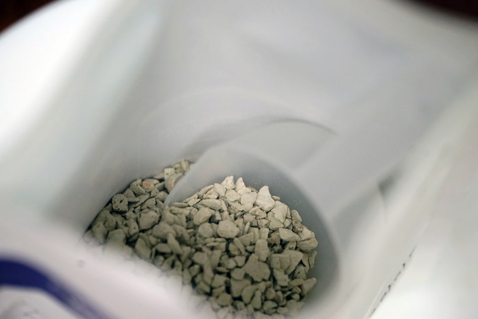 A realistic photo of a state-of-the-art water treatment filtration module with visible zeolite beads