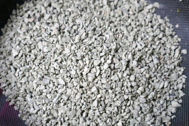 Close-up of a filtration bed showing uniform coating of natural zeolite and other media inside an aq