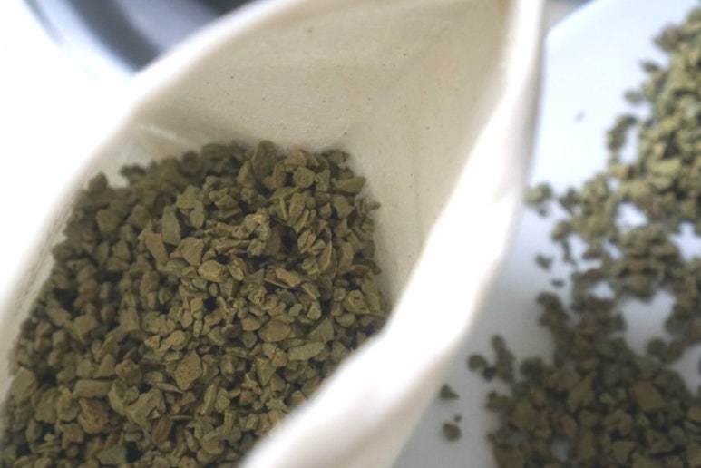 Farmer and agronomist discussing costs and ROI with a notebook and calculator on a farm, background