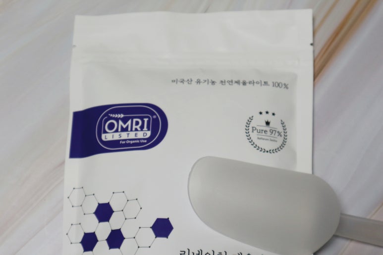 Scientist in a neat lab coat explaining data on a tablet, with a skincare product on the counter, mo