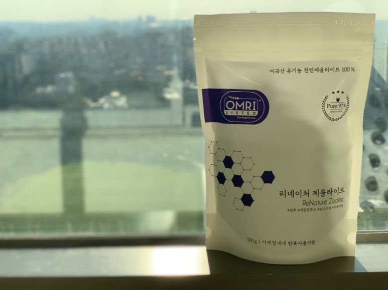 Close-up realistic photo of white zeolite bags laid out on a sunlit windowsill for regeneration, no 