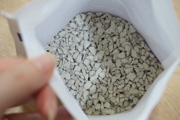 Realistic office scene with a person looking at a tablet displaying an abstract downward bar chart, 