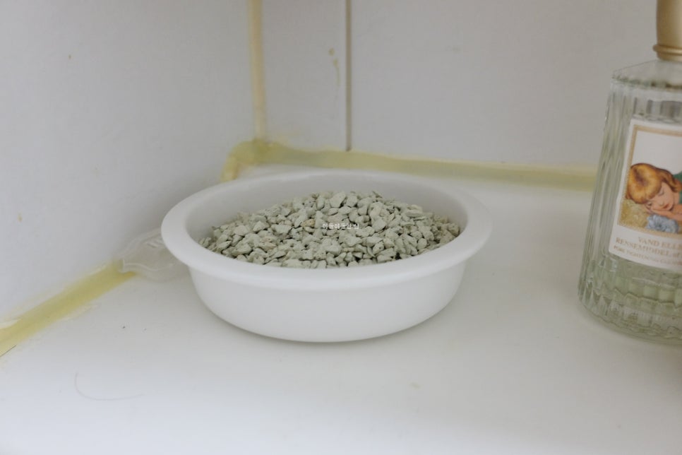 Close-up of a compact dehumidifier and air freshening unit on a bright kitchen counter, ambient ligh