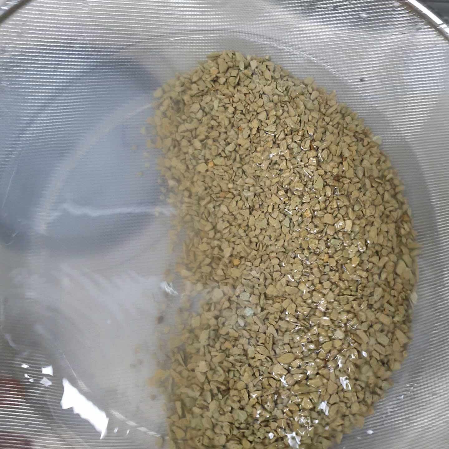 Filtration setup showing water circulating through a mesh bag in a simple home filter, with a clear