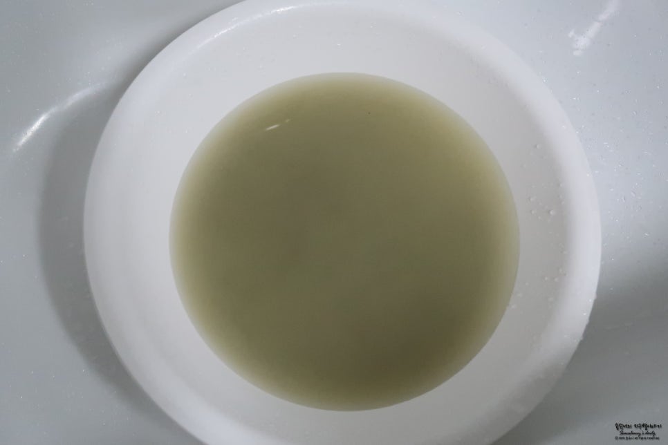 Close-up of an ammonia test kit showing a color change in a tube with a neutral background, suggesti