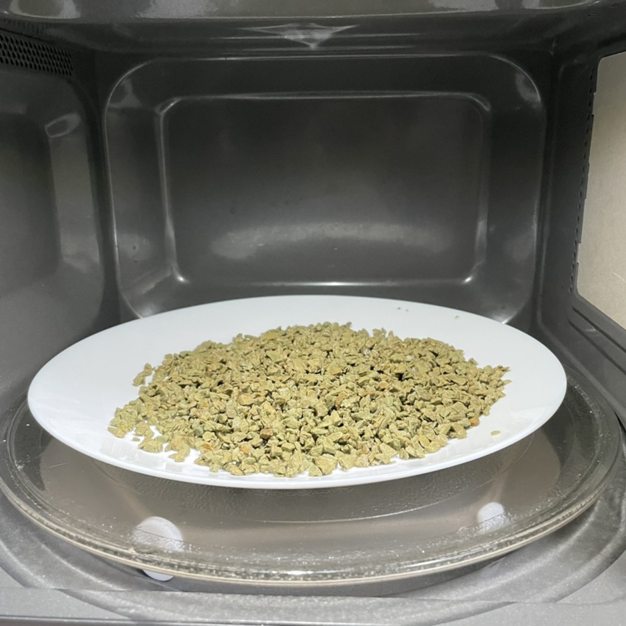 Scientist performing heat treatment in a hydrogen atmosphere inside a sealed chamber, safety gear an