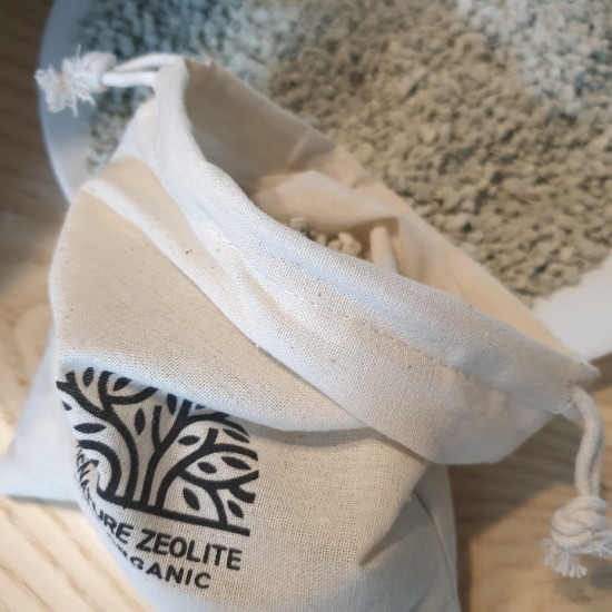 Close-up of a generic 500g package-style zeolite product resting on a kitchen counter, sunlight, min