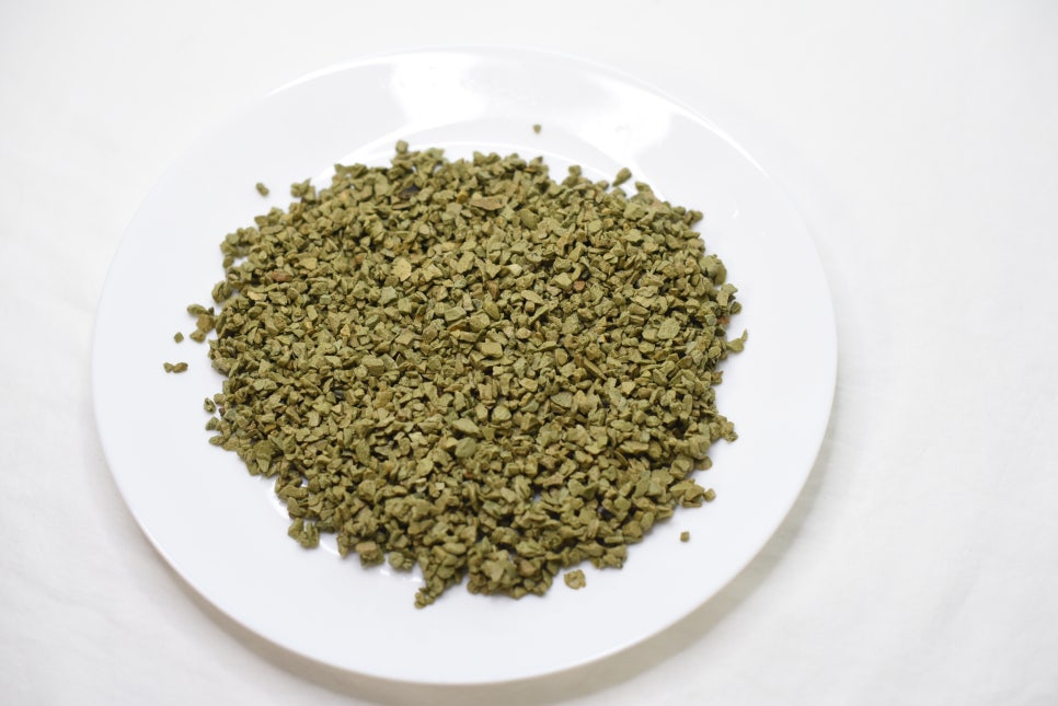 Drought-stressed field where crops remain green and robust due to improved moisture retention from a