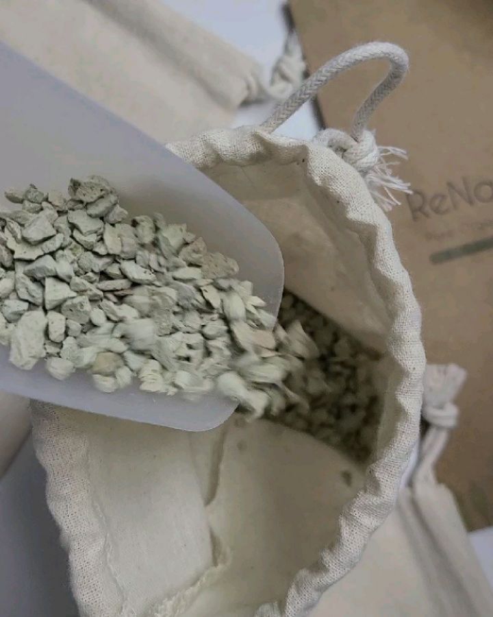 Regeneration scene showing spent zeolite being washed with ethanol in a glass column, with lab equip