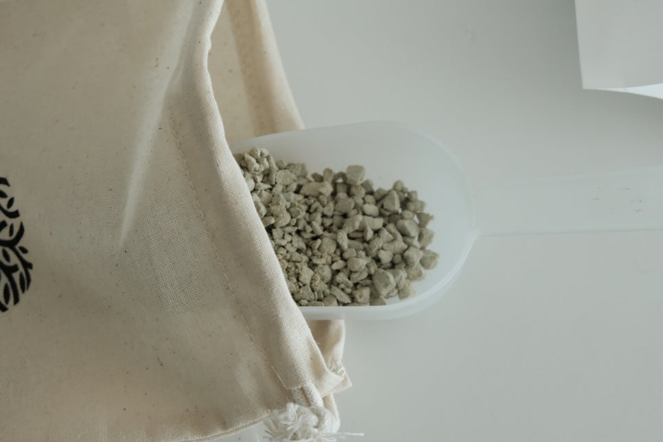 Home or small facility setup with a compact filtration unit and a transparent bag of zeolite beads o