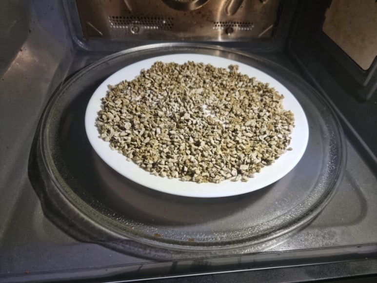 Drying or regeneration setup in a lab showing moisture-damaged zeolite filter and a controlled dryin